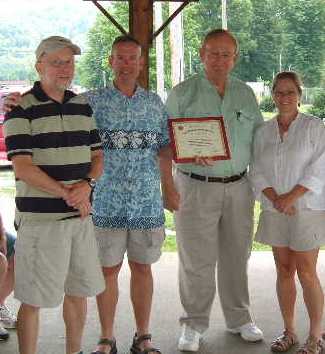 Image Viewer Marshall County Extension Program Assistant, Edgar Hooper, presents Mary Ann Yevuta, Bryan Ensinger, and Bob Lowe with their Master Gardener Certificate